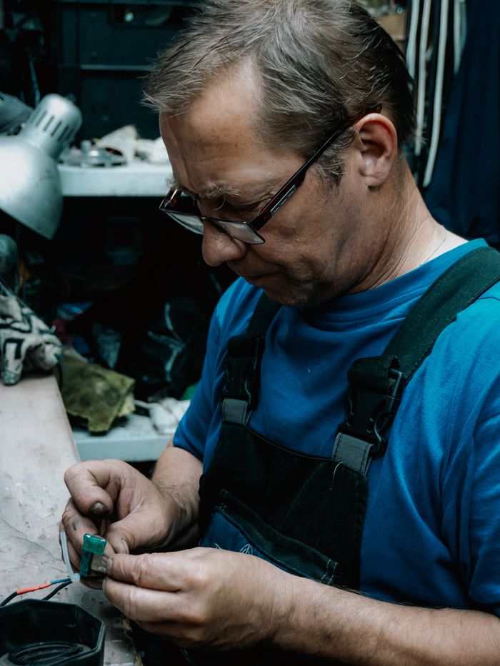 Crafting Captivating Headlines: Your awesome post title goes here Experienced craftsman focuses on intricate detail in a cluttered workshop environment.